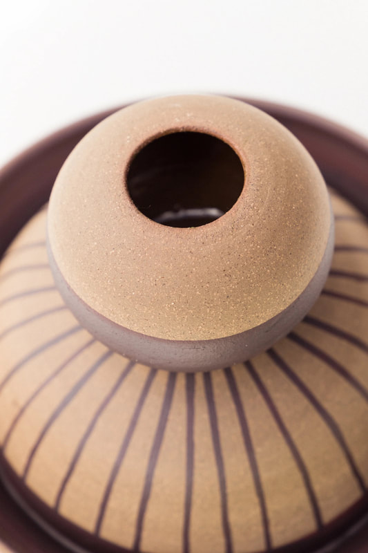 detail of a ceramic vase with stripes handmade by belinda wiltshire